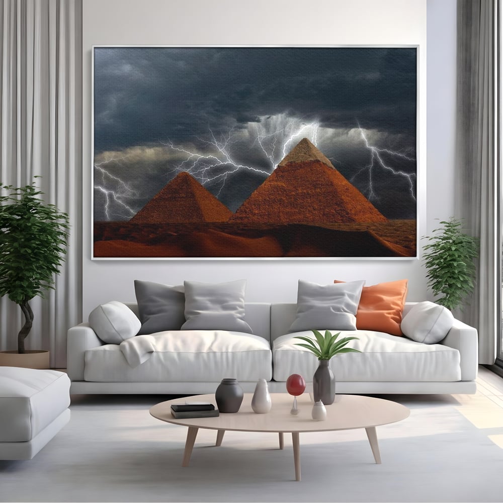 Tablou canvas cu ilustratie cu piramide si fulgere, in rama de aluminiu argintiu, pe perete intr-un living